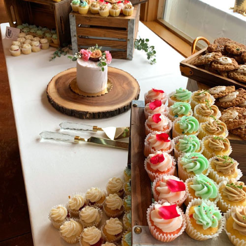 Heritage Bakery dessert table with cupcakes and cookies