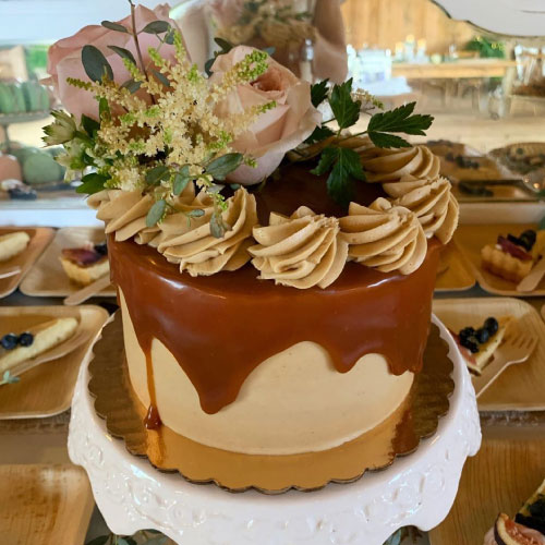 Heritage Bakery wedding cake with caramel and fresh flowers